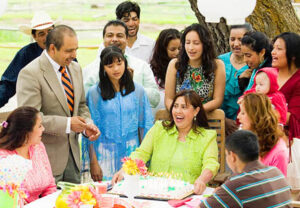 A group of people gathered around a cake.